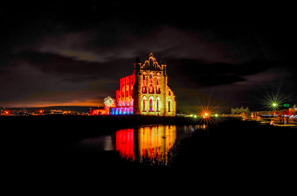 A long exposure night shot at Whitby Abbey during the Goth Week illuminations for Halloween in October 2017